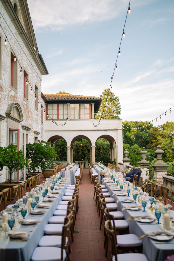 al fresco family style dinner tables setup and styled on the terrace at villa terrace in Milwaukee