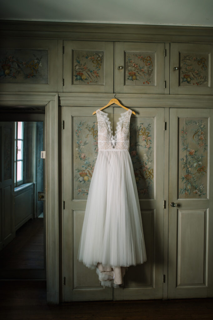bride's dress hanging in green hand painted closet inside villa terrace in Milwaukee Wisconsin